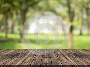 Empty wood table top on nature green blurred background at garden,space for montage show product