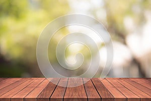 Empty wood table top on nature green blurred background at garden,space for montage show products