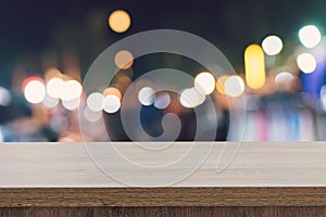 Empty wood table top for product display montage and blurred bokeh night.