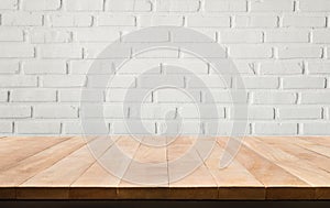 Empty wood table top with white brick wall background.