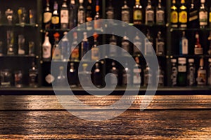 Empty wooden bar counter with defocused background photo