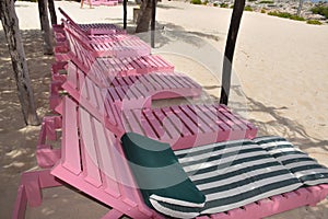 Empty wooden beach chairs photo