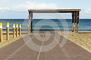 Empty wooden beach walk with blue ocean on background