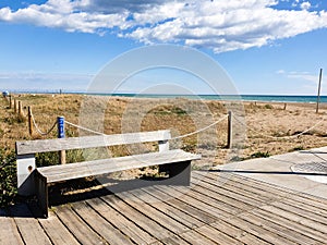 Empty wooden bench on the beach, views of the sea, Castelldefels