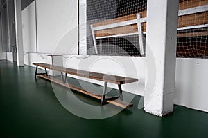 Empty wooden benche in school. Tribune in the gym for fans of matches with empty wooden seats. Lifestyle, game and power