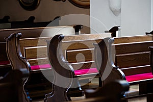 Empty wooden benches in Catholic Church