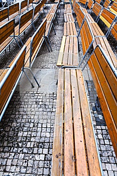 Empty wooden benches on urban square in autumn