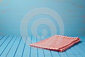 Empty wooden blue table with tablecloth.