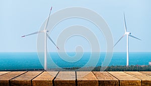 Empty wooden board with copy space for advertising backdrop with renewable energy industry wind turbine background