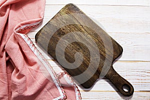 Empty wooden board for food and tablecloth on wooden background top view