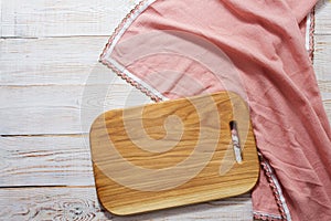 Empty wooden board for food and tablecloth on wooden background top view