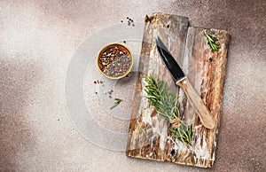 Empty wooden board with herbs and spices on black kitchen table. culinary background, top view