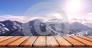 Empty Wooden board top table in front of blurred snow mountain view background. Perspective wood in blurred winter landscape