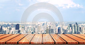 Empty Wooden board top table in front of city blurred background. Perspective wood in blurred city scape background for photo