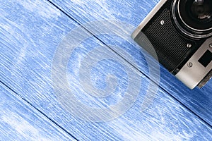 Empty wooden classic blue countertop with vintage camera in the corner