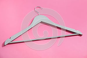 Empty wooden clothes hanger on color