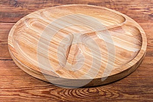 Empty wooden compartmental dish with three departments on the rustic table