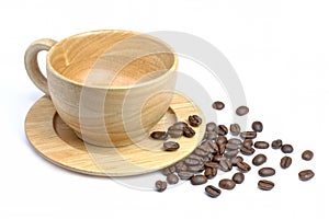 Empty wooden cup of black coffee with roasted coffe beans isolated on white