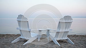 Empty wooden deck chairs on a beach