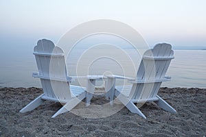 Empty wooden deck chairs on a beach