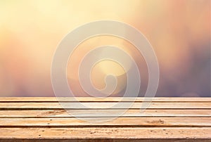 Empty wooden deck table on bokeh background