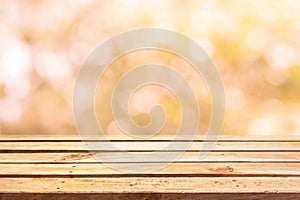 Empty wooden deck table on bokeh background