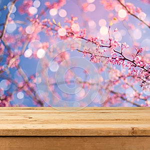 Empty wooden deck table over blurred bokeh spring garden background