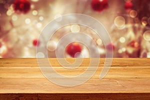 Empty wooden deck table over Christmas bokeh background