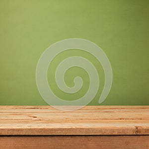 Empty wooden deck table over green wallpaper background. Mock up for product advertise