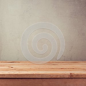 Empty wooden deck table over grey grunge wallpaper