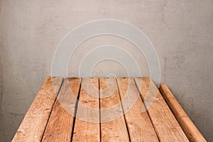 Empty wooden deck table over grunge wall background for product montage