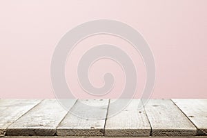 Empty wooden deck table over rusty pink background for present product