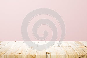 Empty wooden deck table over rusty pink background for present product