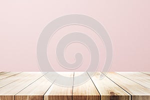 Empty wooden deck table over rusty pink background for present product