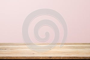 Empty wooden deck table over rusty pink background for present product