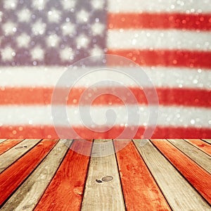 Empty wooden deck table over USA flag bokeh background. USA national holidays background. 4th of July celebration.