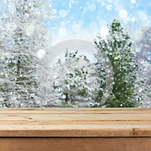 Empty wooden deck table over winter nature background