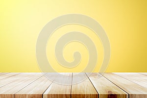 Empty wooden deck table over yellow wallpaper background.