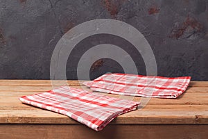 Empty wooden deck table with tablecloth over black wall background