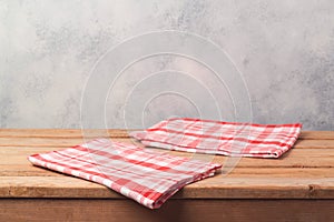 Empty wooden deck table with tablecloth over bright rustic background for product montage