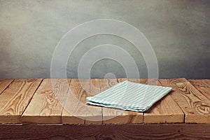 Empty wooden deck table with tablecloth over grunge background. Perfect for product montage display