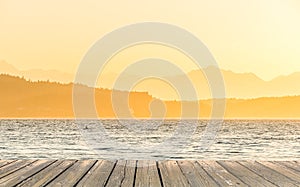 Empty wooden deck table top Ready for product display montage with sea when sunset background.