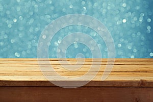 Empty wooden deck table with winter bokeh background. Ready for product display montage.