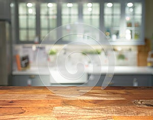 Empty wooden display table top front with blurred kitchen on background