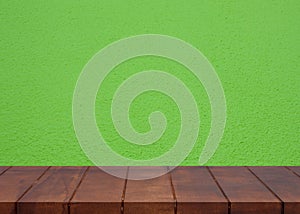 Empty wooden floor.Cement green wall background