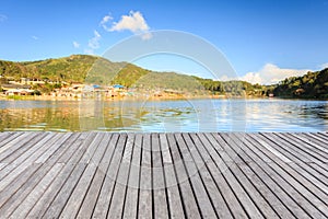 Empty wooden floor or decking beside the lake