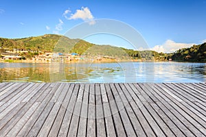 Empty wooden floor or decking beside the lake photo