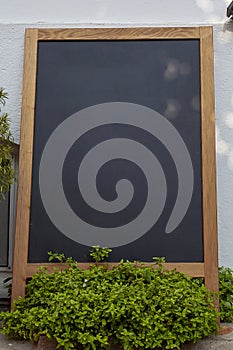 Empty wooden framed chalkboard display for restaurant menus at Tenedos Bozcaada Island by Aegean Sea