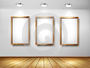 Empty wooden frames on wall with spotlights and wo