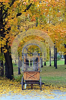 Empty wooden kiosk on wheels.